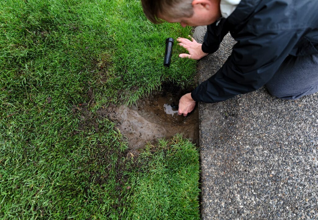 Homeowner working with a trusted local sprinkler repair company in Plano