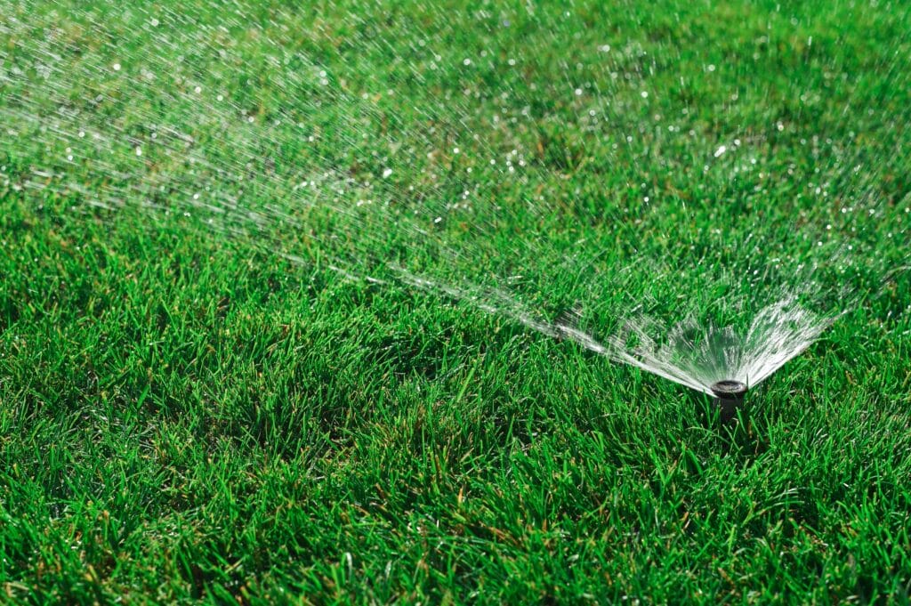 Efficient Irrigation technician repairing a sprinkler valve in Plano, TX